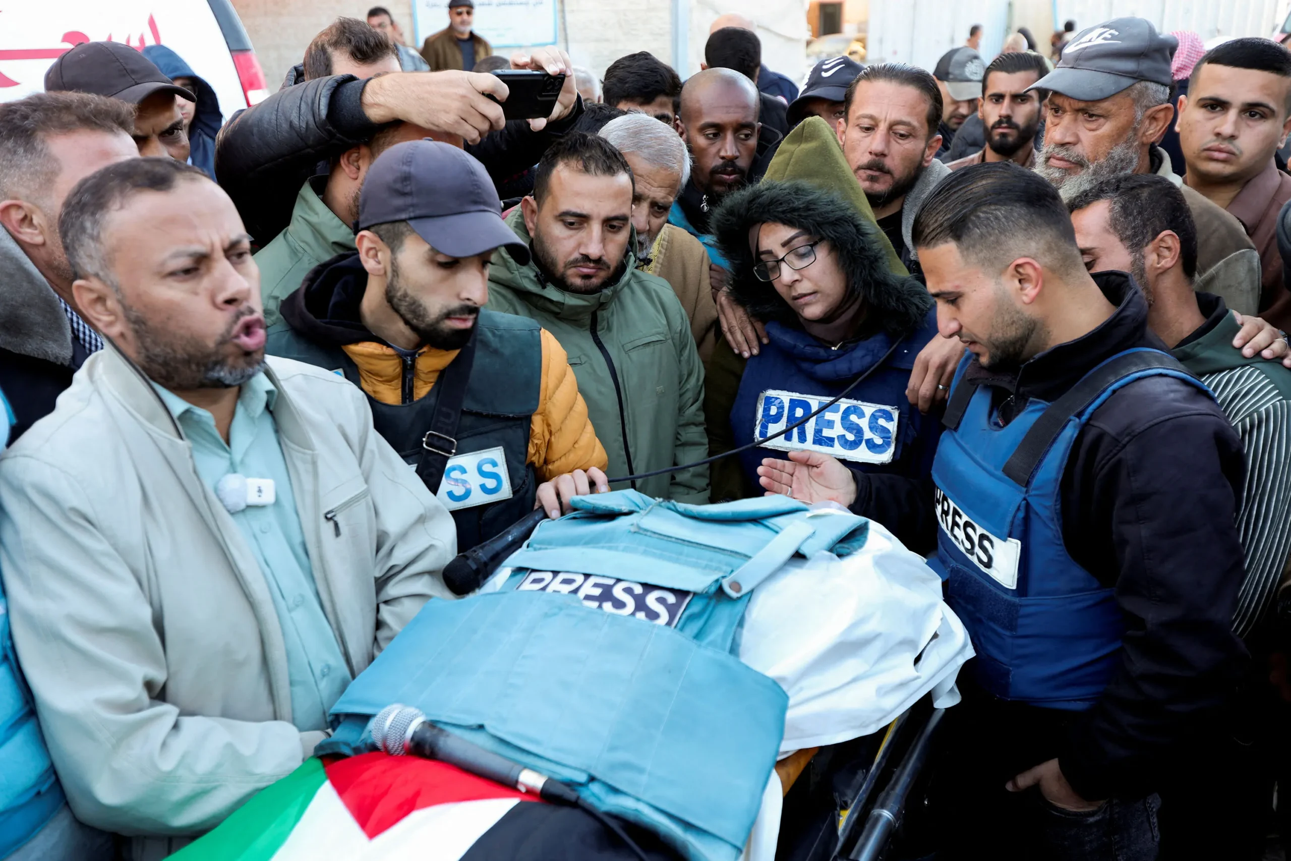 Mourners, including colleagues, attend the funeral of Palestinian Ahmed Al-Louh